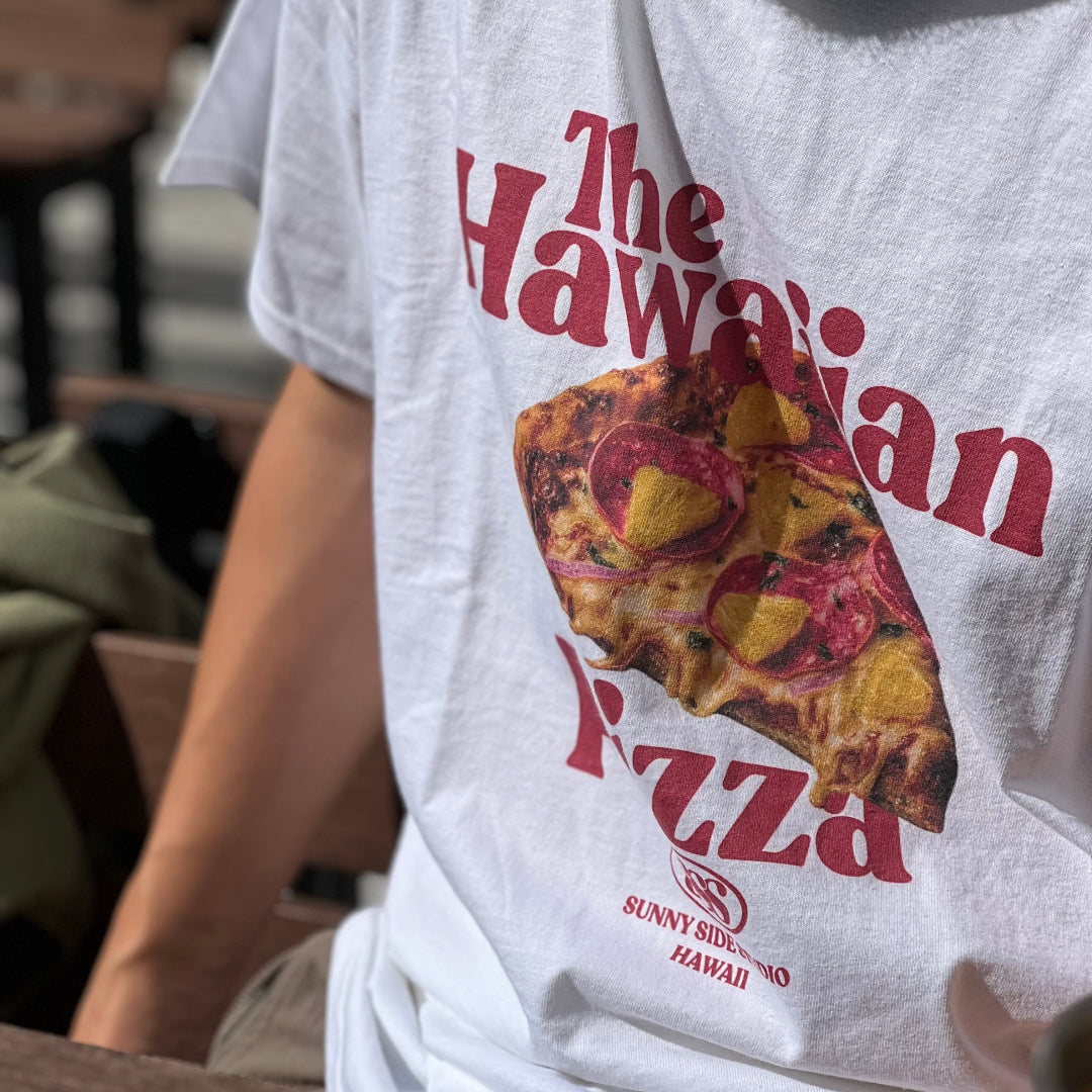 Person wearing a t-shirt with a pizza graphic and text.